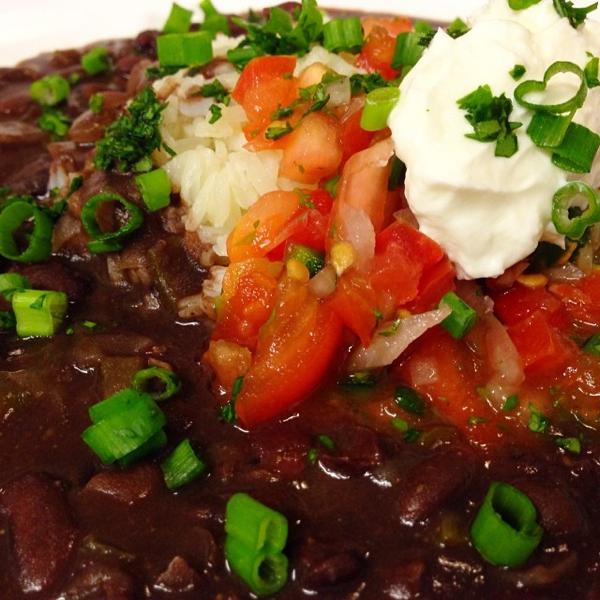 Savory Black Beans and Rice Topped with Sour Cream and Fresh Pico