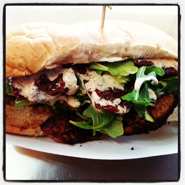 Blackened Tilapia Poboy with baby Arugula, marinated sundried tomatoes and Remoulade sauce
